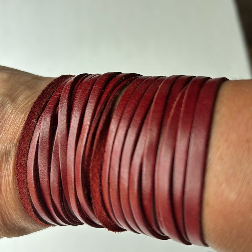 Leather cuff bracelet w three silver clasps.